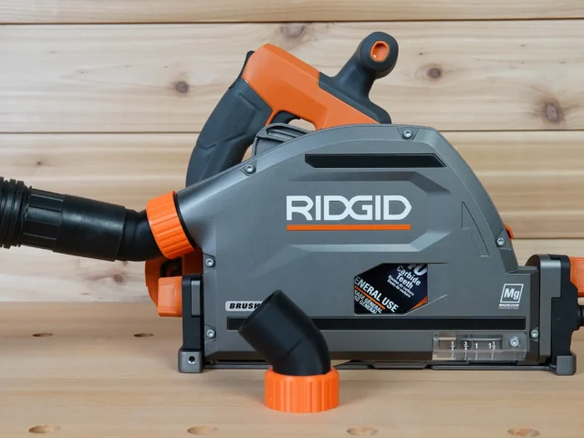 No Snag Dust Port for Ridgid track saw mounted on gray and orange Ridgid track saw, showing angled hose port and quick-change adapter design