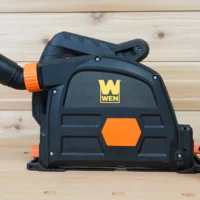 Black and orange no snag dust port adapter attached to a Wen track saw, with removable hose fittings displayed separately