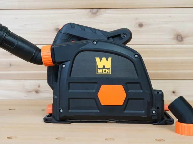 Black and orange no snag dust port adapter attached to a Wen track saw, with removable hose fittings displayed separately