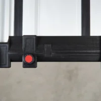 Black 3D-printed hose deflector mounted on Milwaukee track saw guide rails with red quick-release clamping knob, front view