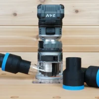 Black ToolCurve 1-7/8 inch hose adapter with blue ring joining a vacuum hose to a FLEX 24v router, plus two spares