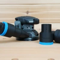 Black and blue 1-7/8 inch ToolCurve hose adapter connected to a Flex sander, with two spare adapters beside it