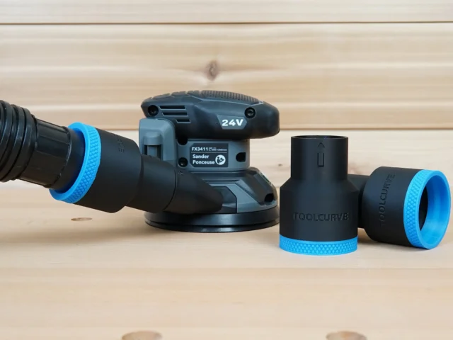 Black and blue 1-7/8 inch ToolCurve hose adapter connected to a Flex sander, with two spare adapters beside it