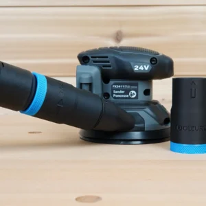 Black ToolCurve hose adapter with blue ribbed collar standing beside a Flex random orbital sander and vacuum hose