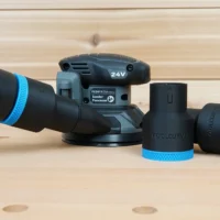 Black 36mm ToolCurve hose adapter with blue trim beside a Flex 24V sander and dust extractor hose