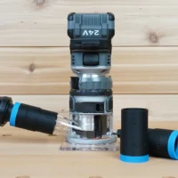 Black 1-1/4" hose adapter with blue collar joining an orange vacuum hose to a FLEX 24v router, plus two spare adapters