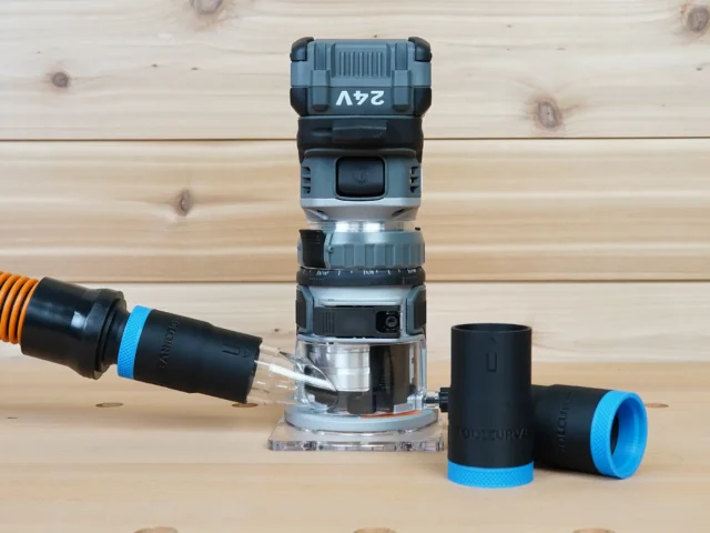 Black 1-1/4" hose adapter with blue collar joining an orange vacuum hose to a FLEX 24v router, plus two spare adapters