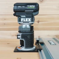 ToolCurve guide rail adapter mounted on FLEX 24v brushless router, connected to aluminum track saw rail on wooden workbench