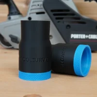 Black ToolCurve hose adapter with blue textured grip band, shown standalone and installed on Porter Cable belt sanders in background