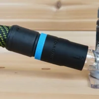 Black hose adapter with blue band attached to green and black braided hose, connected to FLEX 24v router dust port
