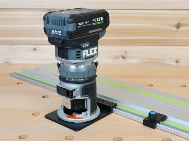 FLEX 24V router mounted on black adapter base, positioned on aluminum guide rail with green laser line