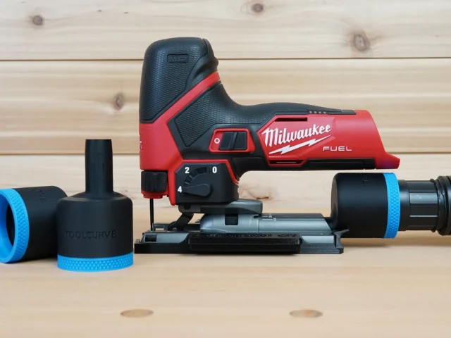 Black ToolCurve 1-7/8 inch hose adapter with blue ring beside a Milwaukee M12 Fuel jig saw and vac hose