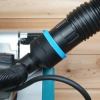 Black ToolCurve 2-1/2 inch hose adapter with blue ring installed on a Makita miter saw dust port