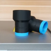 Black cylindrical ToolCurve hose adapter with blue grip bands, shown standalone next to a ruler for scale