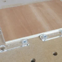 Clear acrylic fence stops with aluminum bench dogs mounted on a wooden workbench with 20mm dog holes