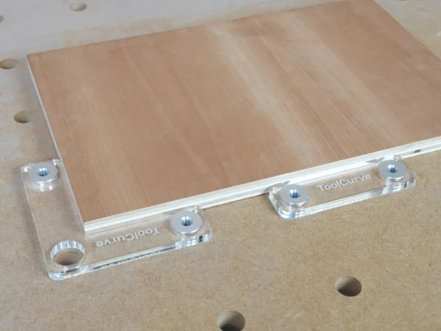 Clear acrylic fence stops with aluminum bench dogs mounted on a wooden workbench with 20mm dog holes