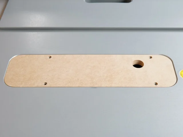 Bosch 4100 table saw zero clearance insert, MDF with rounded corners, four mounting holes and one center opening, shown from above