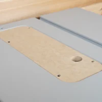 Wooden zero clearance insert for FLEX table saw, showing rounded edges, mounting holes, and a centered blade opening