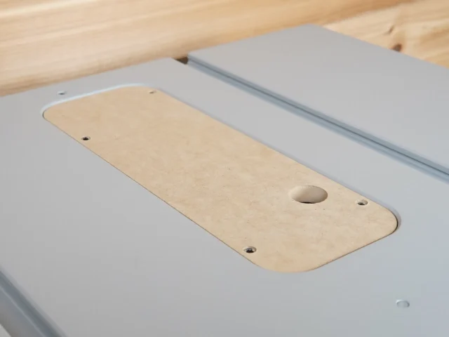 Wooden zero clearance insert for FLEX table saw, showing rounded edges, mounting holes, and a centered blade opening