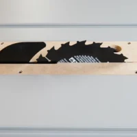 Zero clearance insert for FLEX 8-1/4" table saw, MDF base with cutouts for saw blade profiles, two mounting holes visible
