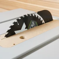 Zero clearance insert for FLEX 10" table saw, with blade installed through wooden base and mounted in saw slot