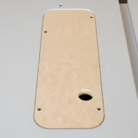 Tan MDF zero clearance insert for FLEX 8-1/4" table saw, shown from above with oval blade opening and four mounting holes