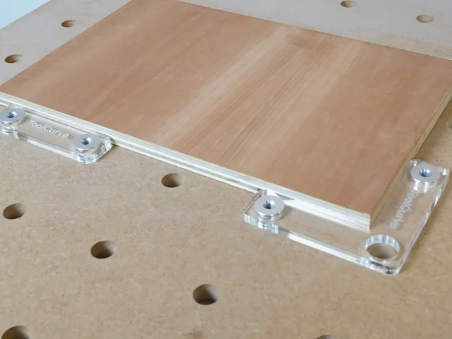 Clear acrylic fence stops with aluminum 20mm bench dogs seated in workbench holes
