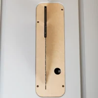 Tan laminated wood insert plate with centered vertical slot and mounting holes, designed for a FLEX 10-inch table saw