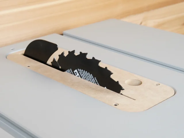 MDF zero clearance insert installed in a FLEX 8-1/4in table saw with blade and riving knife raised through the slot