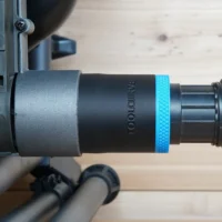 Black 1-7/8 inch ToolCurve hose adapter with blue ring joining a vacuum hose to a SKIL table saw dust port