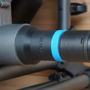 Black ToolCurve hose adapter with blue textured ring joining a SKIL table saw dust port to a vacuum hose