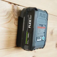 ToolCurve battery mount holding a FLEX 24v lithium battery mounted horizontally on wooden wall