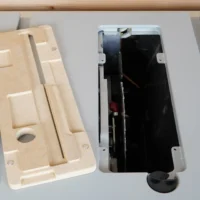 Cream-colored MDF zero clearance insert for Bosch GTS18 table saw, shown beside the original black metal insert to display fit and design differences