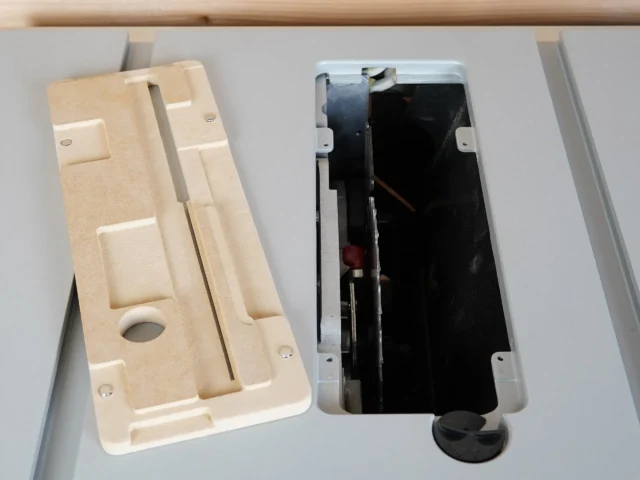 Cream-colored MDF zero clearance insert for Bosch GTS18 table saw, shown beside the original black metal insert to display fit and design differences