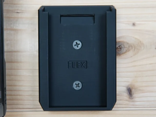 Black plastic FLEX battery mount with recessed slot and two Phillips screws, shown front view