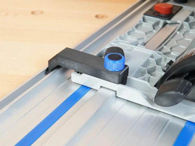 Anti-Tip Guide mounted on Kreg ACS track saw with blue knob tightened, installed on aluminum rail with blue tape