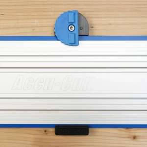 Blue 3D-printed wall mount with knurled locking knob clipped onto a Kreg Accu-Cut guide rail, top view