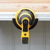 Yellow and black Mirka sander mounted in a holder attached to an aluminum MFT/3 rail, showing 2.5 marking on the sander head