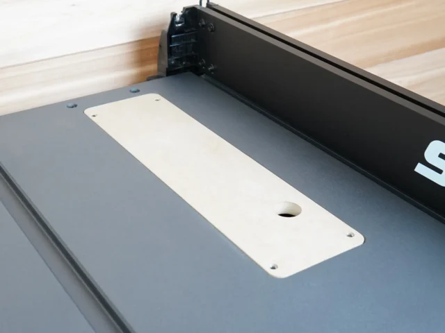 White MDF zero clearance insert mounted on SKIL 10" TS6307 table saw with central blade opening and offset screw holes