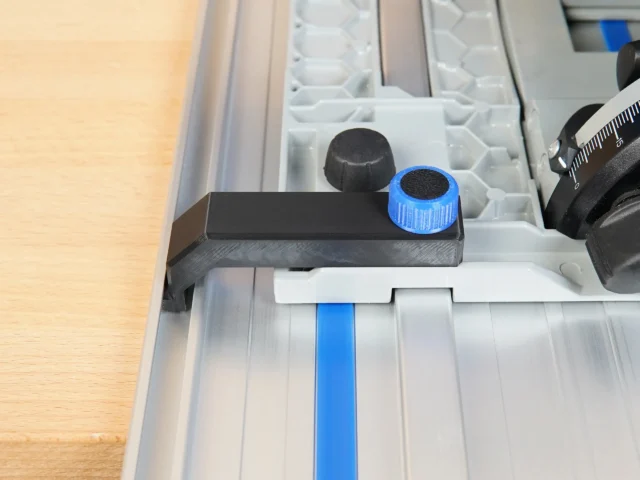 Anti-Tip Guide for Kreg ACS track saw mounted on aluminum rail, showing black PETG body with blue adjustment knob and black knob
