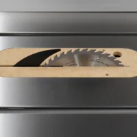 Light wood MDF insert with curved edges and mounting holes, containing two saw blades in a horizontal slot