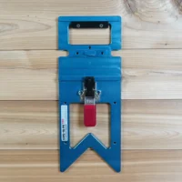 Blue wall mount holder with red clamp lever, designed to hold a Festool guide rail square vertically on a shop wall or cabinet