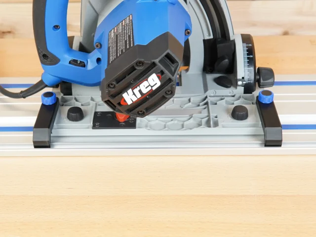 Anti-Tip Guide mounted on Kreg ACS track saw, showing black PETG adapter securing saw to blue guide rail during angled cut setup