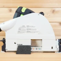 Black textured arbor dust cover installed on the side of a white Festool TS 75 EQ track saw, side view