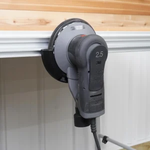 Black sander holder in an MFT/3 side T-track, cradling a gray 3M Xtract 2.5 orbital sander pad-out