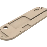 Tan 3D-printed insert plate viewed from back, showing curved slots, mounting holes, and recessed channels for SawStop table saw