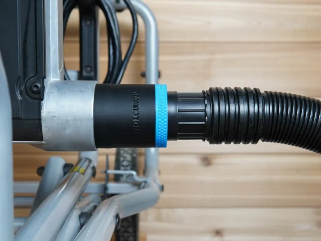 Black ToolCurve 1-7/8 inch hose adapter with blue ring joining a ribbed shop vac hose to a Kobalt table saw dust port