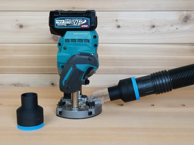 Black 2-1/2 inch ToolCurve hose adapter with blue ring joining a vac hose to a Makita 40v XGT plunge router, second adapter beside it