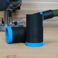 Black ToolCurve hose adapter with blue grip bands, shown standalone and installed on Makita 40v XGT cordless plunge router in background
