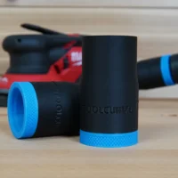 Two black hose adapters with blue grip rings shown with a red Milwaukee random orbit sander in the background